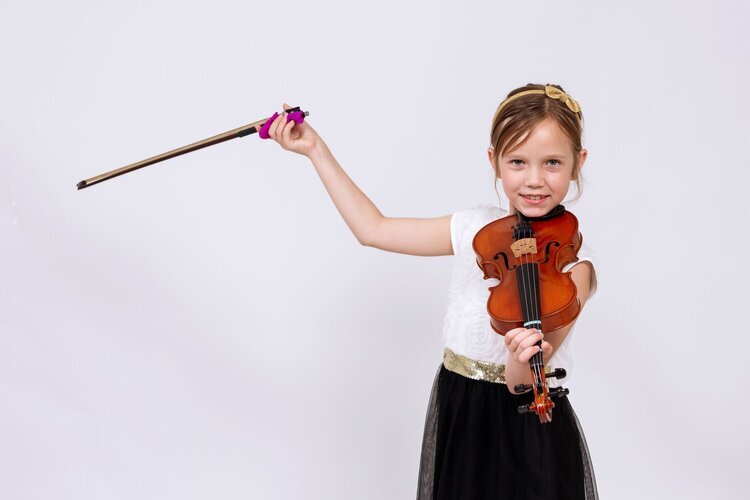 Young violin player holding her bow